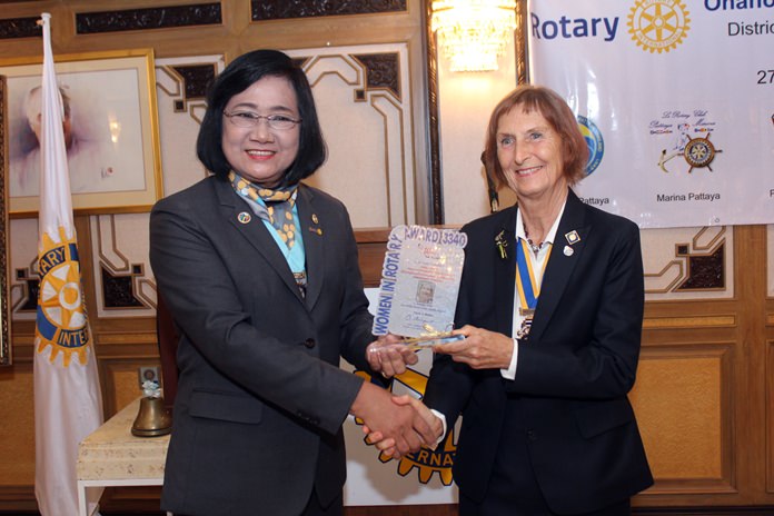 DG Onanong presents the Outstanding Women in Rotary Award to President Dr. Margret Deter.