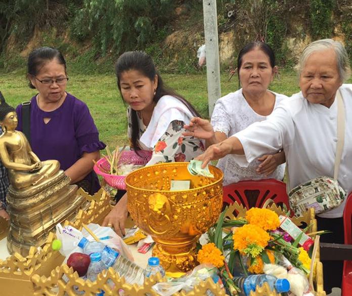 People take part in alms giving at Wat Boonsampan.