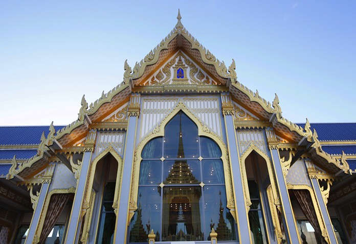 The royal crematorium and funeral complex for the late Thai King Bhumibol Adulyadej is reflected in a pavilion window. (AP Photo/Sakchai Lalit)