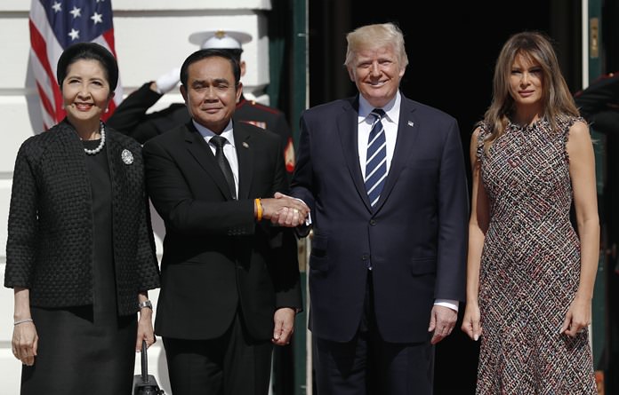 President Donald Trump and first lady Melania Trump greet Thailand's Prime Minister Prayuth Chan-ocha, and his wife Naraporn Chan-ocha, Monday, Oct. 2, 2017, as they arrive at the White House in Washington. (AP Photo/Carolyn Kaster)