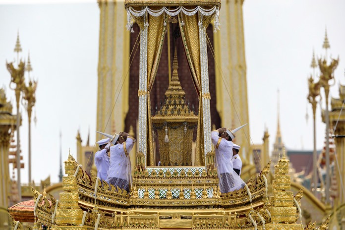 Bearers of the Royal Urn pay their respects during the funeral procession and royal cremation ceremony of late King Bhumibol Adulyadej. (AP Photo/Kittinun Rodsupan)