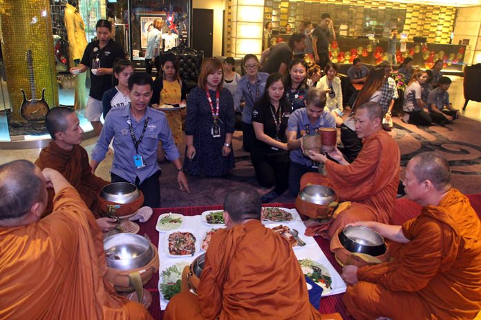 Monks receive offerings of food and necessities from the staff.