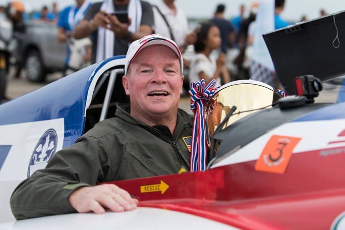 Tim Cone of the USA holds the trophy in his aircraft cockpit after winning the gold class at the Air Race 1 World Cup Thailand event held at U-Tapao Air Base from November 17-19.