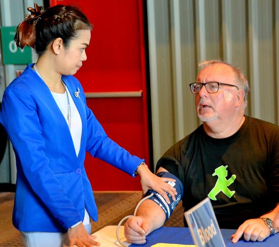 PCEC Members and guests take advantage of the free blood pressure checks being given by nurses from Bangkok Hospital Pattaya.