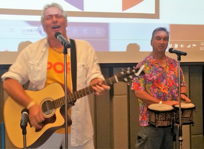 Pattaya Musician Barry Upton on guitar accompanied by Paul Rosenberg on bongos, entertain their PCEC audience with many songs that had everyone tapping their toes.