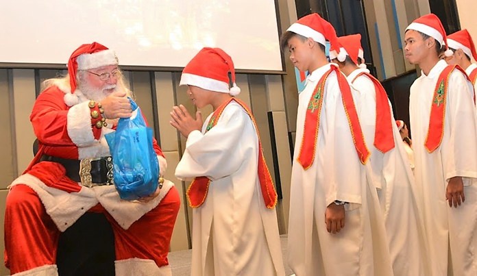 After their performance, as the children from the Pattaya Orphanage Choir leave the stage, they receive presents and a few kind words from Santa. PCEC members and guests donated over 105,000 baht of which about 63,000 baht was used to purchase the presents and the remainder given to the Orphanage for their use.