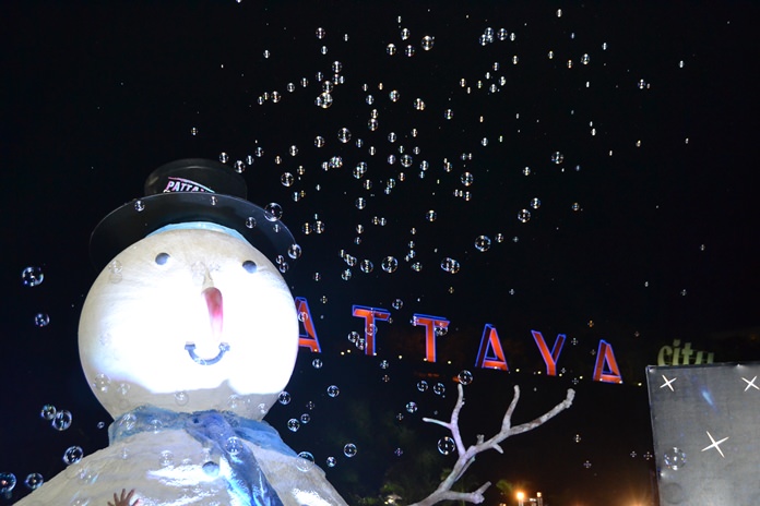 This snowman is enjoying his tiny bubbles, in the air.