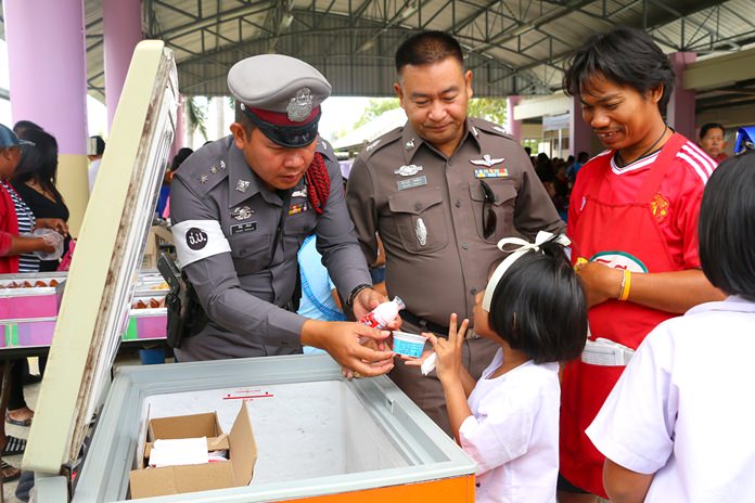 “I’ll take two, please,” this little one says at the free ice cream cooler in Wat Najomtien School.
