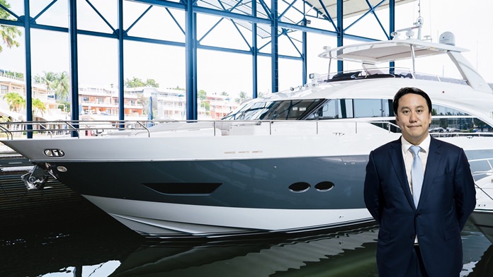 Vrit Yongsakul, Managing Director of Boat Lagoon Yachting Co., Ltd., is photographed with a Princess yacht.