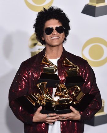 Bruno Mars poses in the press room with his awards at the 60th annual Grammy Awards ceremony in New York, Sunday, Jan. 28. (Photo by Charles Sykes/Invision/AP)