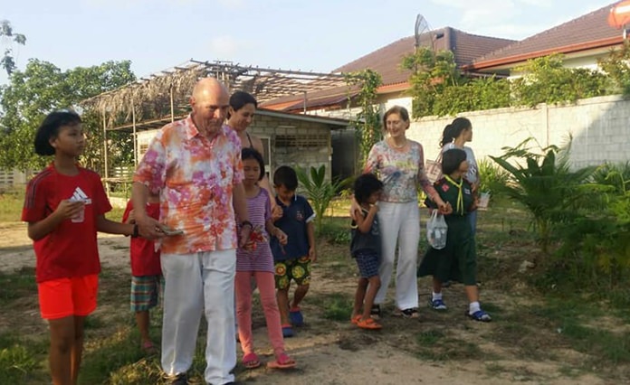 Dr. Otmar Deter, Charter President of the Rotary E Club Dolphin Pattaya International, and President Margaret Dieter are shown around the new organic garden.