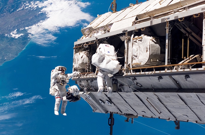FILE - In this Dec. 12, 2006, file photo, made available by NASA, astronaut Robert L. Curbeam Jr., left, and European Space Agency astronaut Christer Fuglesang, participate in a spacewalk during construction of the International Space Station. Under President Donald Trump’s 2019 proposed budget released, Monday, Feb. 12, 2018, U.S. government funding for the space station would cease by 2025. (NASA via AP, File)