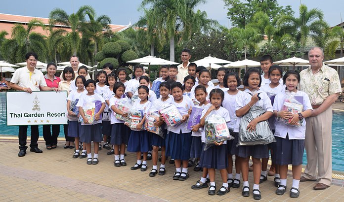 Management of the Thai Garden Resort presents gifts to the orphans.