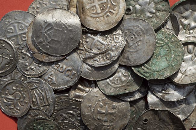The April 13, 2018 photo shows medieval Saxonian, Ottoman, Danish and Byzantine coins after a medieval silver treasure had been found near Schaprode on the northern German island of Ruegen in the Baltic Sea. (Stefan Sauer/dpa via AP)