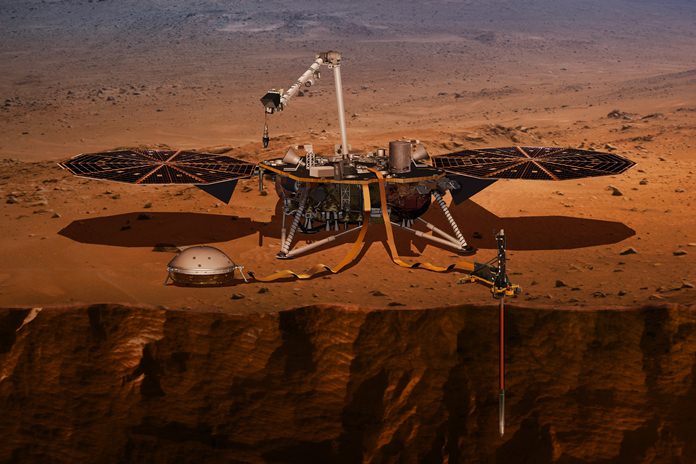 This illustration shows the InSight lander drilling into Mars. (NASA via AP)