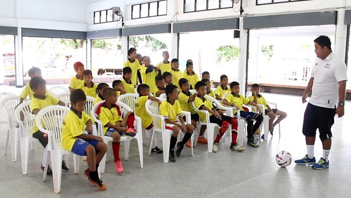A Pattaya United trainer teaches the kids the basics of football.