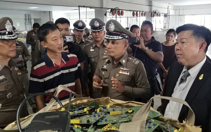 In this photo taken Thursday, May 24, a factory processing electronic waste is visited by police in Lat Krabang, outside Bangkok. (Royal Thai Police via AP)