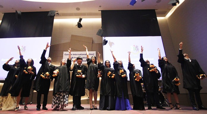 We did it! GIS students throw their mortarboards in the air to mark the end of their IB studies.