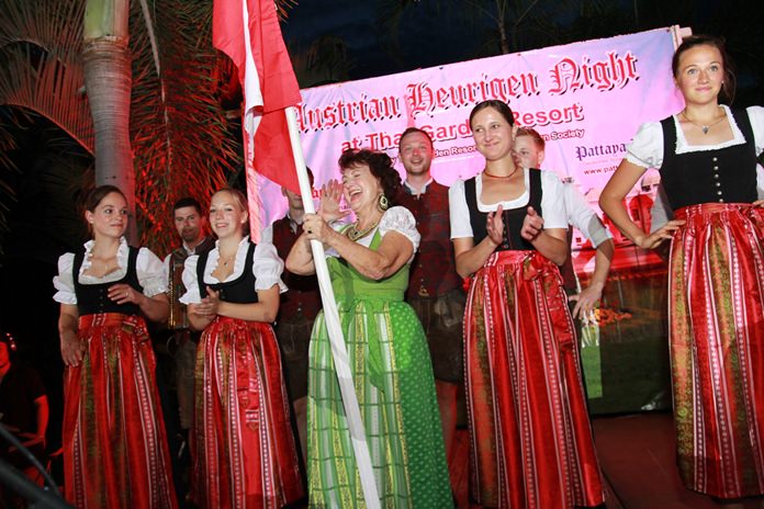 Elfi Seitz holding the Austrian flag shouts out a traditional yodel, supported by the ‘Silberplattler’ dancers.