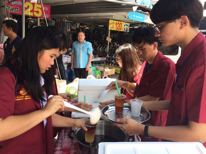 Thammasat University students hand out food and cold drinks as part of the school’s “New Era Kids” project.