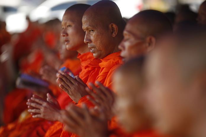 Buddhist monks pray Sunday, July 1, for the 12 boys and their soccer coach. (AP Photo/Sakchai Lalit, File)