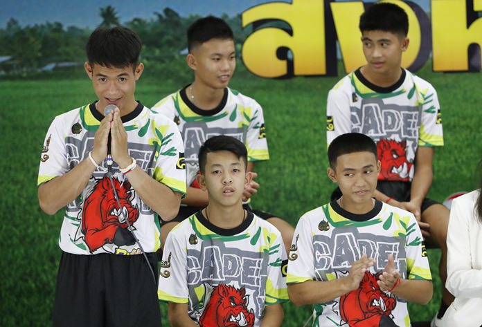 Coach Ekkapol Janthawong, left, and members of the rescued soccer team express their thanks during a press conference in Chiang Rai, Wednesday, July 18. (AP Photo/Vincent Thian)