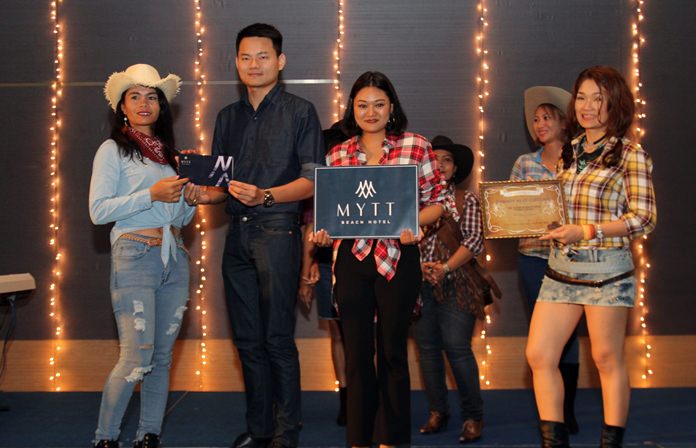 Rachan Buahin, Sales Manager of Mytt Beach resort presents one of the raffle prizes sponsored by the hotel.