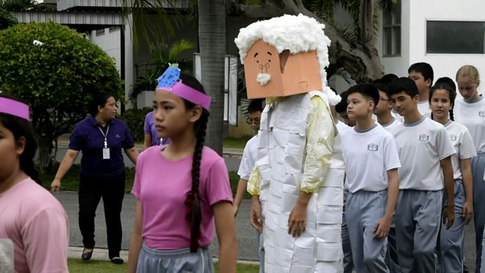 Students bring out a cardboard Albert Einstein during the opening parade.