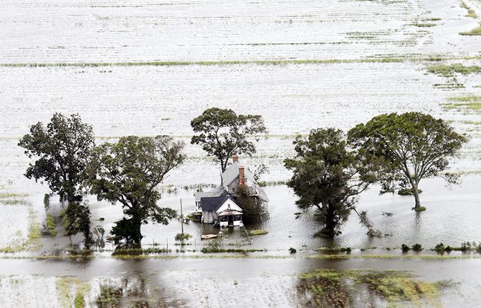 A farm house is surrounded by flooded fields from tropical storm Florence in Hyde County, N.C., Saturday, Sept. 15. (AP Photo/Steve Helber)