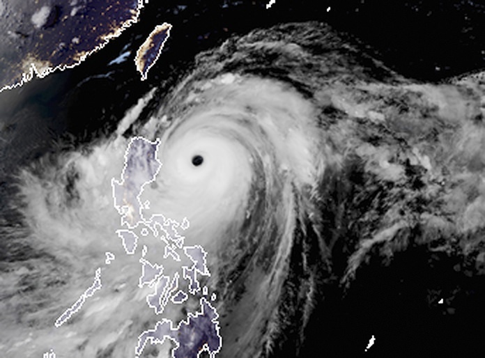 A satellite image with land graphic borders shows the width and trajectory of Typhoon Mangkhut as it approaches the Philippines, Friday, Sept. 14. (RAMMB and CIRA via AP, File)