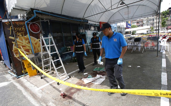 A police forensics team investigates a shooting scene where one tourist was killed in Bangkok, Monday, Oct. 8. (AP Photo/Sakchai Lalit)