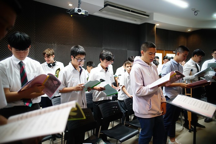 Baritone singers practice their parts that will be combined with other sounds in the whole choir practice before the concert.