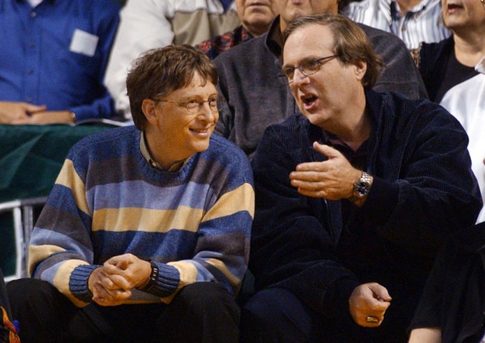 Microsoft Chairman Bill Gates, left, chats with Portland Trail Blazers owner and former business partner Paul Allen during a game between the Trail Blazers and Seattle SuperSonics in Seattle.  (AP Photo/Elaine Thompson, File)