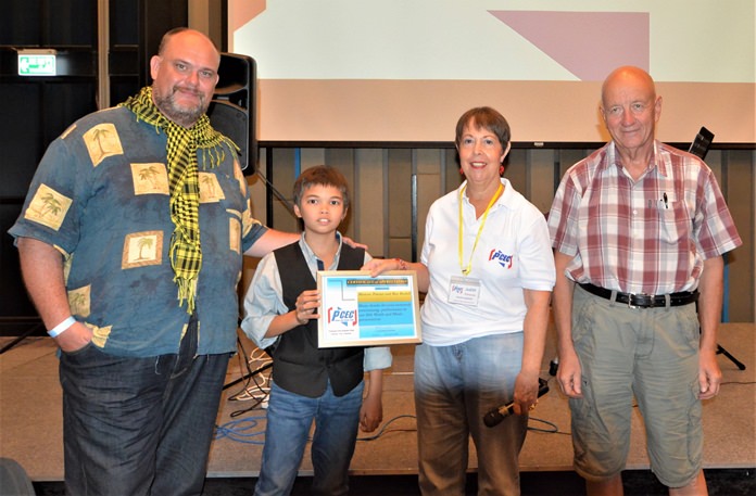 MC Judith Edmonds presents the PCEC’s Certificate of Appreciation to Ben Rudolf for his entertaining and informative presentation, while Ben’s father, Bill Gustafsson (far right) and Marcus Tristan (far left) look on.