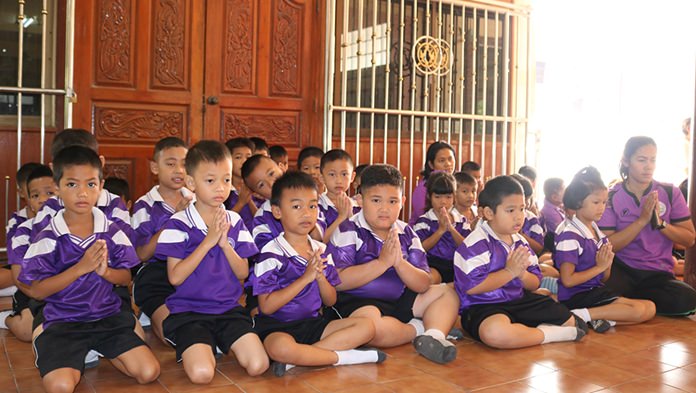 Students of Ban Nongprue School participate in morning activities during Auk Pansaa at Wat Nongprue.