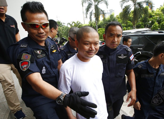 In this Thursday, July 20, 2017 file photo, ex-monk Wirapol Sukphol is escorted by the Department of Special Investigation officials to the prosecutor's office in Bangkok. (AP Photo/Sakchai Lalit)