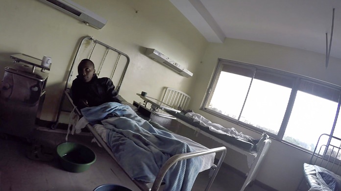 Detained patients lie on beds in the Kenyatta National Hospital in Nairobi, Kenya on Monday, Aug. 6, 2018. At east Africa’s biggest medical institution, and at an astonishing number of other hospitals around the world, if you don’t pay up, you don’t go home. (AP Photo/Desmond Tiro)