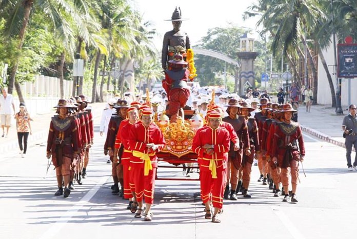 The royal parade makes its way through city streets.