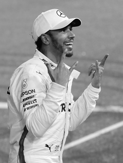 Mercedes driver Lewis Hamilton of Britain celebrates his victory after the Emirates Formula One Grand Prix at the Yas Marina racetrack in Abu Dhabi, United Arab Emirates, Sunday, Nov. 25. (AP Photo/Luca Bruno)