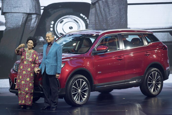 Malaysia Prime Minister Mahathir Mohamad (right) poses with his wife Siti Hasmah during the launch of Proton new SUV in Kuala Lumpur, Malaysia, Wednesday, Dec. 12. (AP Photo/Vincent Thian)