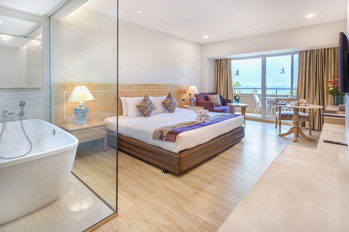 Ocean Deluxe room features white and sandy tan accents, marble bathroom and amenities.