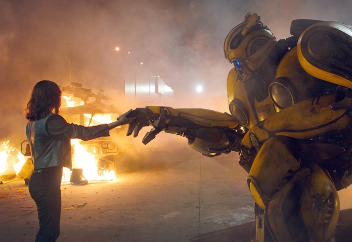 This image released by Paramount Pictures shows Hailee Steinfeld as Charlie and Bumblebee in a scene from "Bumblebee." (Will McCoy/Paramount Pictures via AP)