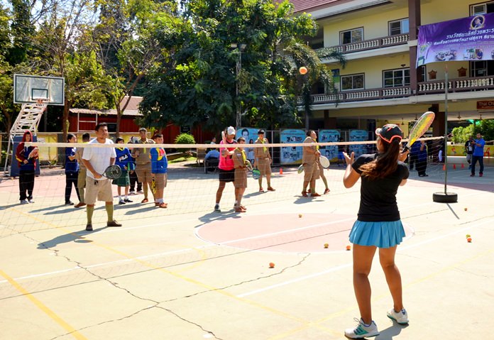 Learning how to play from a member of the Pattaya Tennis Lovers Club.