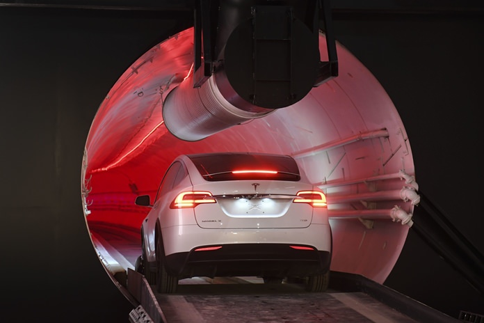 A modified Tesla Model X drives in the tunnel entrance before an unveiling event for the Boring Co. Hawthorne test tunnel in Hawthorne, Calif., Tuesday, Dec. 18. (Robyn Beck/Pool Photo via AP)
