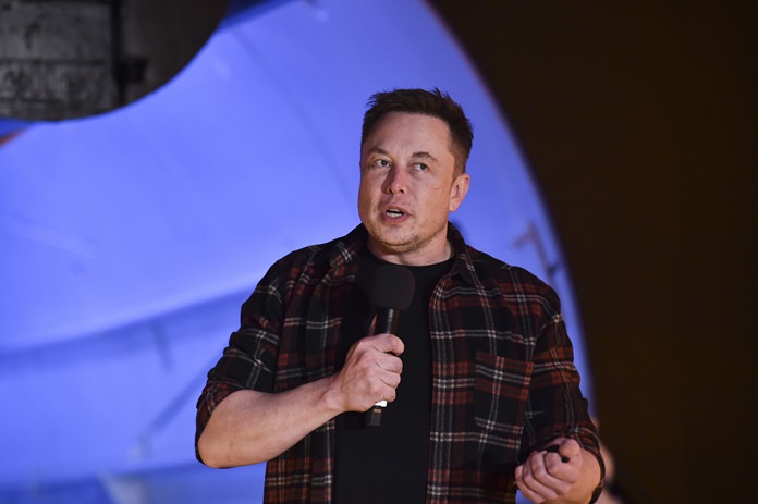 Elon Musk, co-founder and chief executive officer of Tesla Inc., speaks during the test tunnel unveiling event in Hawthorne, Calif., Tuesday, Dec. 18. (Robyn Beck/Pool Photo via AP)