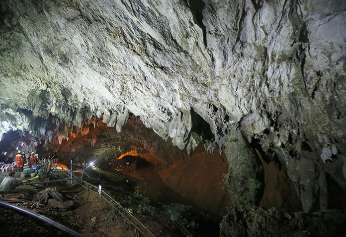 Rescuers work at the entrance to a cave complex where 12 soccer team members and their coach went missing, in Mae Sai, Chiang Rai province, in northern Thailand, on June 30, 2018. (AP Photo/Sakchai Lalit)