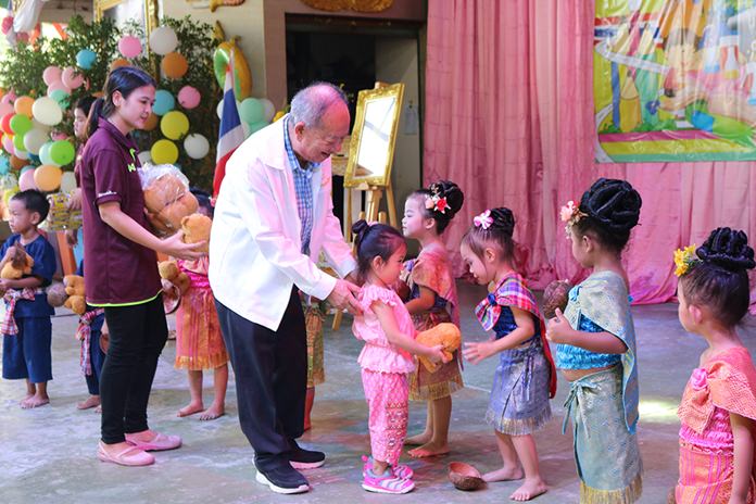 Nongprue Mayor Mai Chaiyanit hands out presents to little children under his care.
