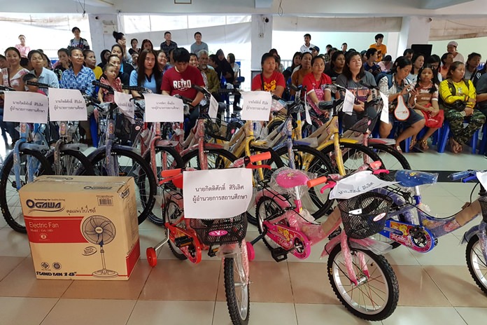 Families at Nongprue Nursery School wait in anticipation as bicycles are about to be awarded to deserving children.