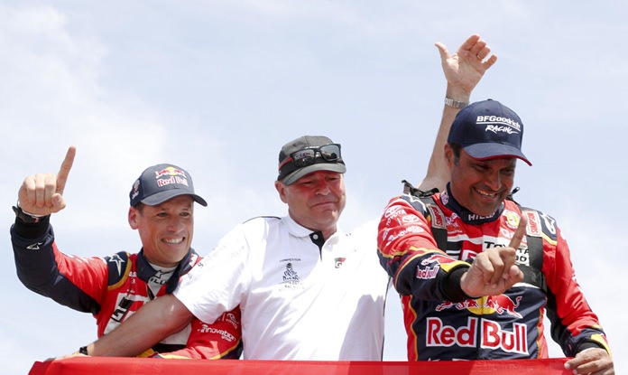 Driver Nasser Al-Attiyah, of Qatar (right) and co-driver Matthieu Baumel, of France (left) celebrate with Toyota team manager Glyn Hall after winning the Dakar Rally at the arrival of the last stage in Pisco, Peru, Thursday, Jan. 17. (AP Photo/Ricardo Mazalan)
