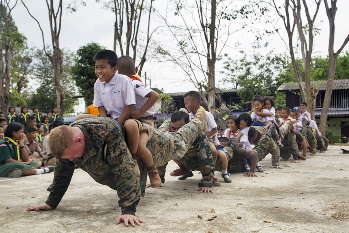 U.S., Indian, and Royal Thai service members and students at the Ban Wang Mai Daeng School participate in a group push-up activity during Cobra Gold 19 at Ban Wang Mai Daeng School, Chanthaburi, Feb. 6, 2019. (U.S. Marine Corps photo by Lance Cpl. Kenny Nunez.)